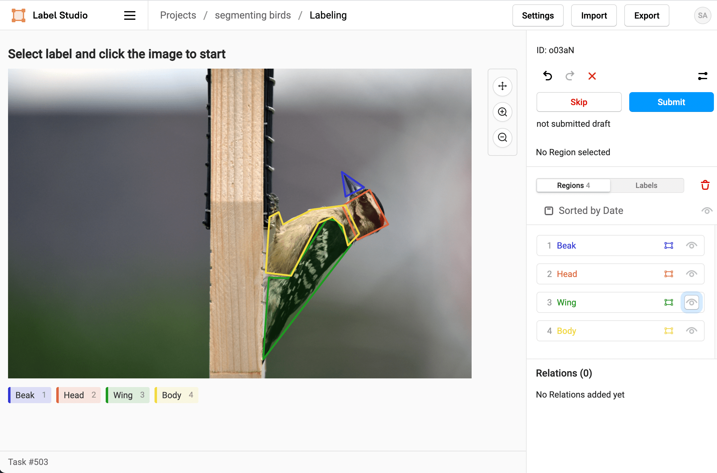 Screenshot of the Label Studio labeling UI with a woodpecker sitting on a bird feeder with the beak, head, wing, and body labeled with different colored polygons, and the labeled regions visible on the right hand sidebar.